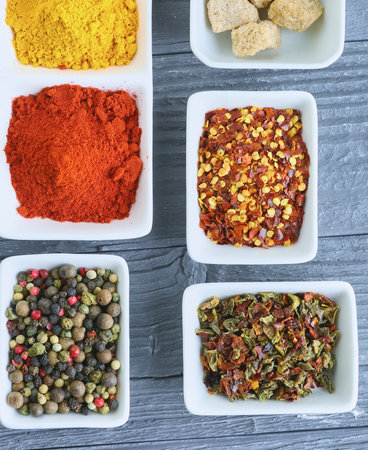Various spices in a bowls on gray backgroundの写真素材