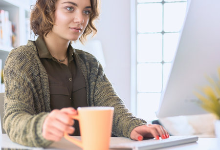 Student studying and learning online with a laptop in a desk at homeの写真素材