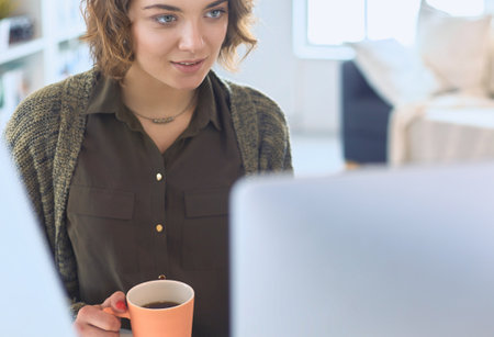 Young woman or student using tablet computer at homeの写真素材