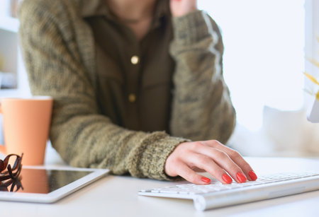 Young woman looking in laptop display watching training courseの写真素材