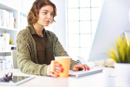 Student studying and learning online with a laptop in a desk at homeの写真素材