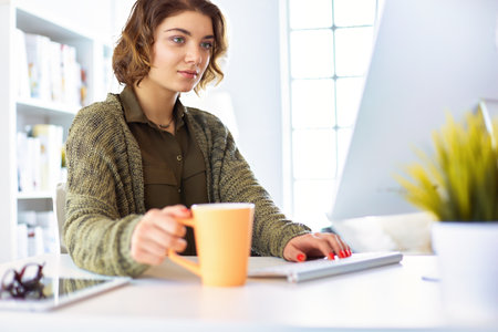 Student studying and learning online with a laptop in a desk at homeの写真素材