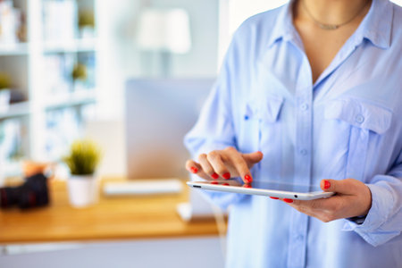 Portrait of an attractive professional photographer woman and using a tabletの写真素材