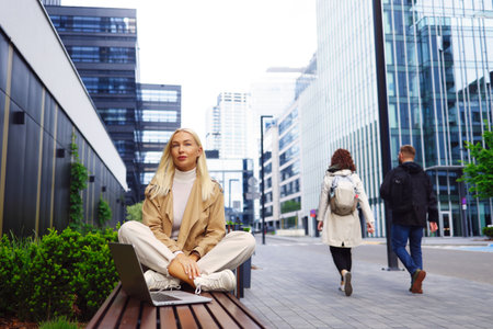 Calm business woman meditating in lotus outdoorsの写真素材