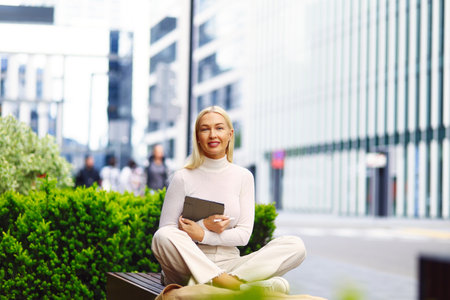 Calm business woman meditating in lotus outdoorsの写真素材