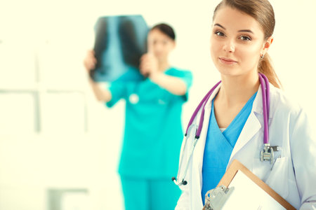 Woman doctor standing with folder at hospitalの写真素材