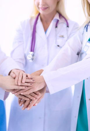 Doctors and nurses in a medical team stacking handsの写真素材