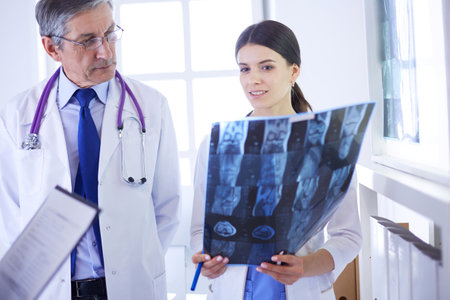 Group of doctors checking x-rays in a hospitalの写真素材