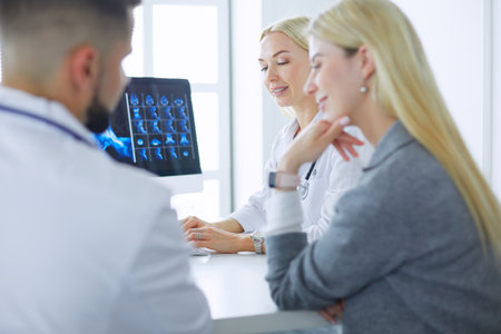 Doctor woman shows the patient chest x-rayの写真素材