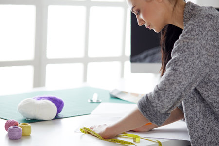 Woman American fashion designer working in atelier.の写真素材