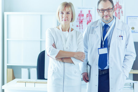 Doctors smiling at camera in medical officeの写真素材
