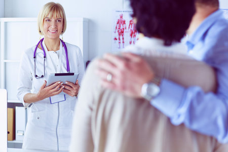 Medical doctor and young couple patients in hospitalの写真素材