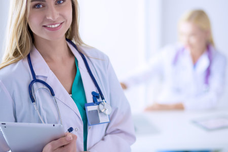 Woman doctor standing with stethoscope at hospital . Woman doctorの写真素材