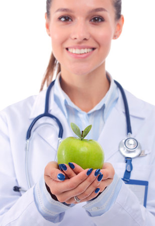 Smiling woman doctor with a green apple. Woman doctorの写真素材