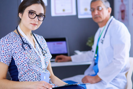 A medical team of doctors, man and woman,standing in officeの写真素材