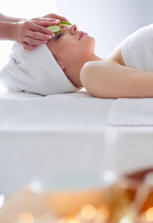 Young woman lying on a massage table,relaxing with eyes closed. Woman. Spa salonの写真素材