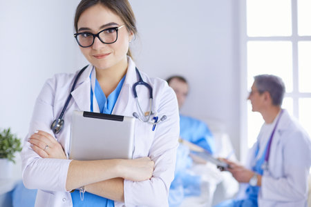 Female doctor using tablet computer in hospital lobbyの写真素材