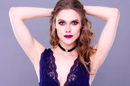 Beautiful woman with evening make-up and curly hair .の写真素材