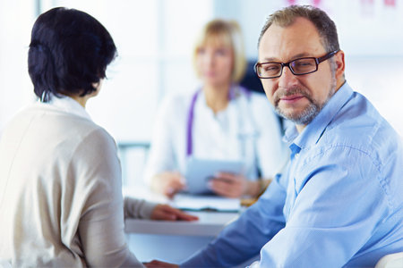 American doctor talking to woman in surgeryの写真素材