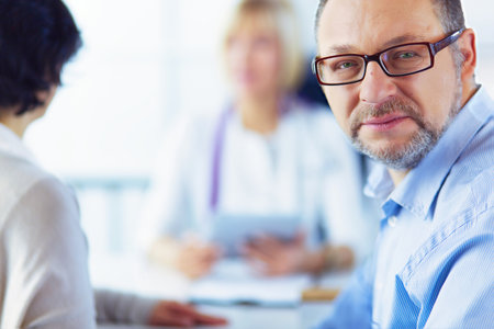 American doctor talking to woman in surgeryの写真素材