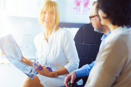 Medical doctor looking at a x-ray image in the officeの写真素材