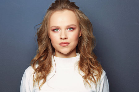 Portrait of beautiful woman model with fresh daily makeup and romantic wavy hairstyleの写真素材