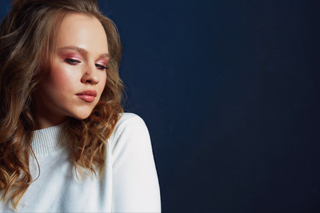 Portrait of beautiful woman model with fresh daily makeup and romantic wavy hairstyleの写真素材