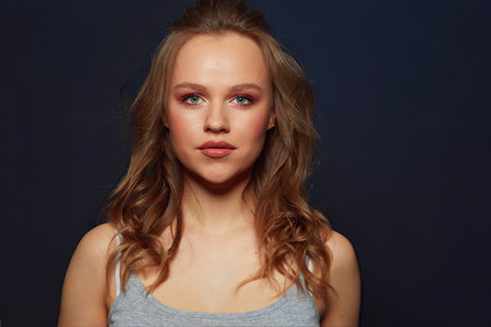 Beautiful womans face with tan. clean skin - isolated on blackの写真素材
