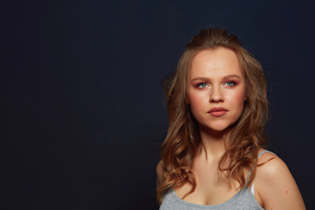 Beautiful womans face with tan. clean skin - isolated on blackの写真素材