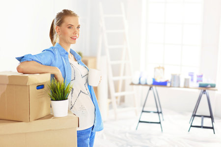 Beautiful young woman moving to new homeの写真素材