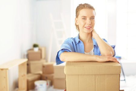 Beautiful young woman moving to new homeの写真素材