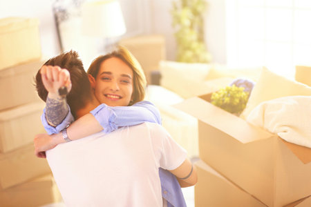 Happy smiling young couple showing a keys of their new houseの写真素材
