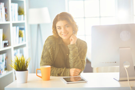 Student studying and learning online with a laptop in a desk at homeの写真素材
