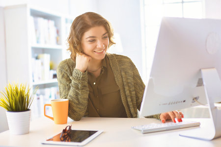 Beautiful smiling female student using online education serviceの写真素材