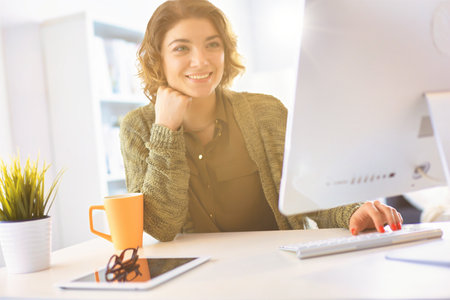 Beautiful smiling female student using online education serviceの写真素材