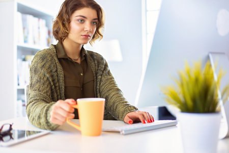 Student studying and learning online with a laptop in a desk at homeの写真素材