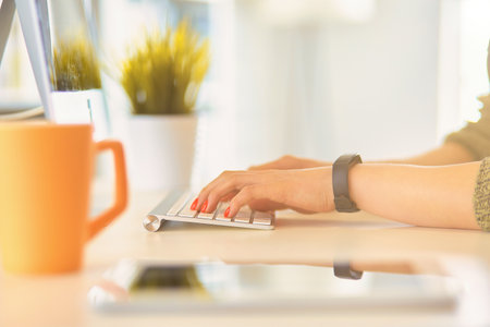 Closeup of businesswoman typing on laptop computerの写真素材