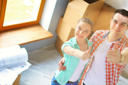 Portrait of young couple moving in new home. Young coupleの写真素材