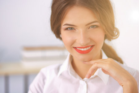 Attractive businesswoman sitting in the officeの写真素材