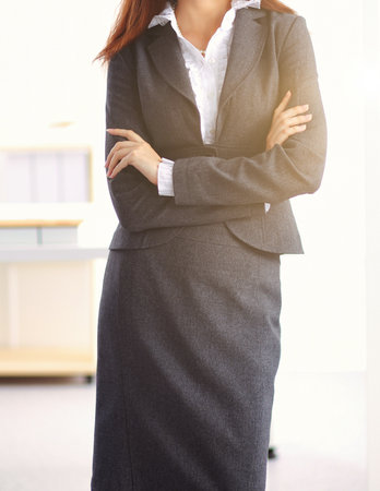Portrait of business woman standing with crossed arms in office.の写真素材