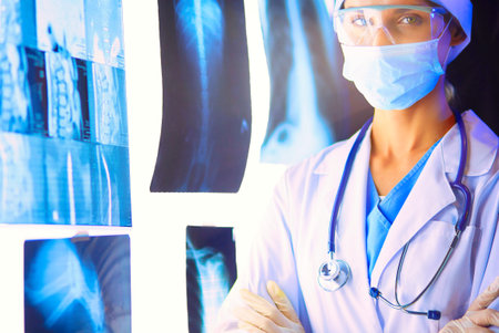 Image of attractive woman doctor looking at x-ray resultsの写真素材