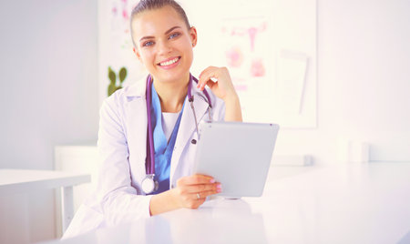 Close up Portrait of friendly female doctor with stethoscope smiling at camera.の写真素材
