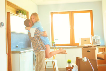 Portrait of young couple moving in new home. Young coupleの写真素材
