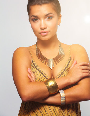 Young beautiful brunette woman with beadsの写真素材