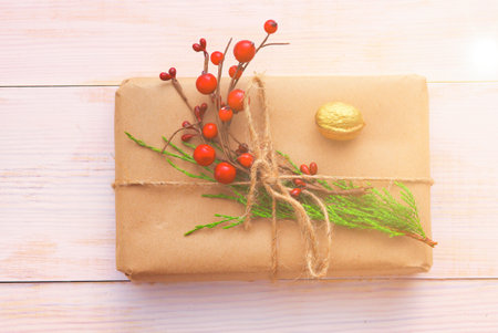 Christmas gift boxes and fir tree branch on wooden table, flat layの写真素材