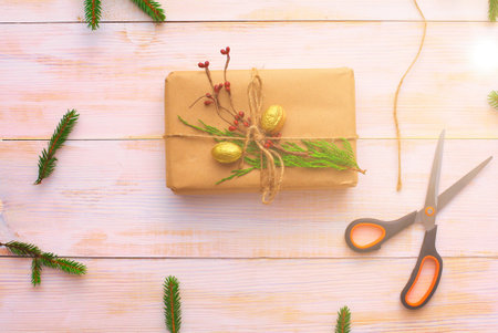 Christmas gift boxes and fir tree branch on wooden table, flat layの写真素材