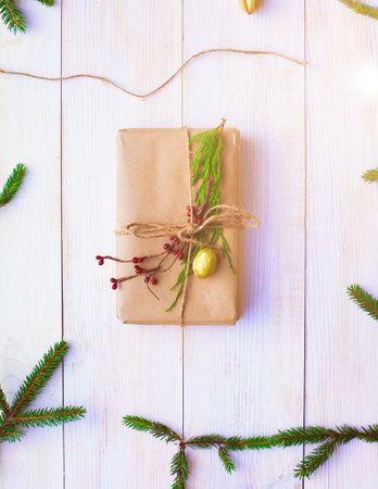 Christmas gift boxes and fir tree branch on wooden table, flat layの写真素材