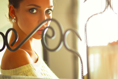 Portrait of a cute woman in sweater at homeの写真素材