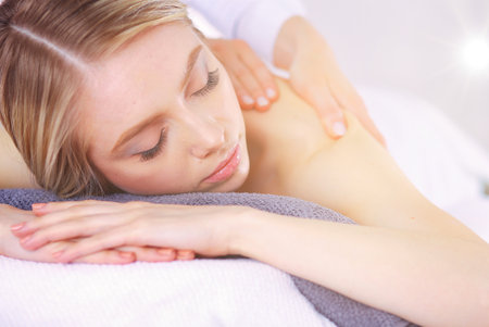 Young woman lying on a massage table,relaxing with eyes closed. Woman. Spa salonの写真素材