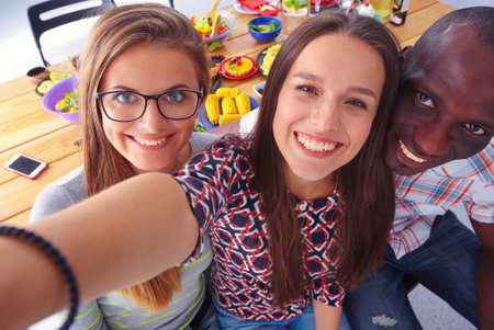 Group of people doing selfie during lunch. Self. Friends. Friends are photographed for eatingの写真素材